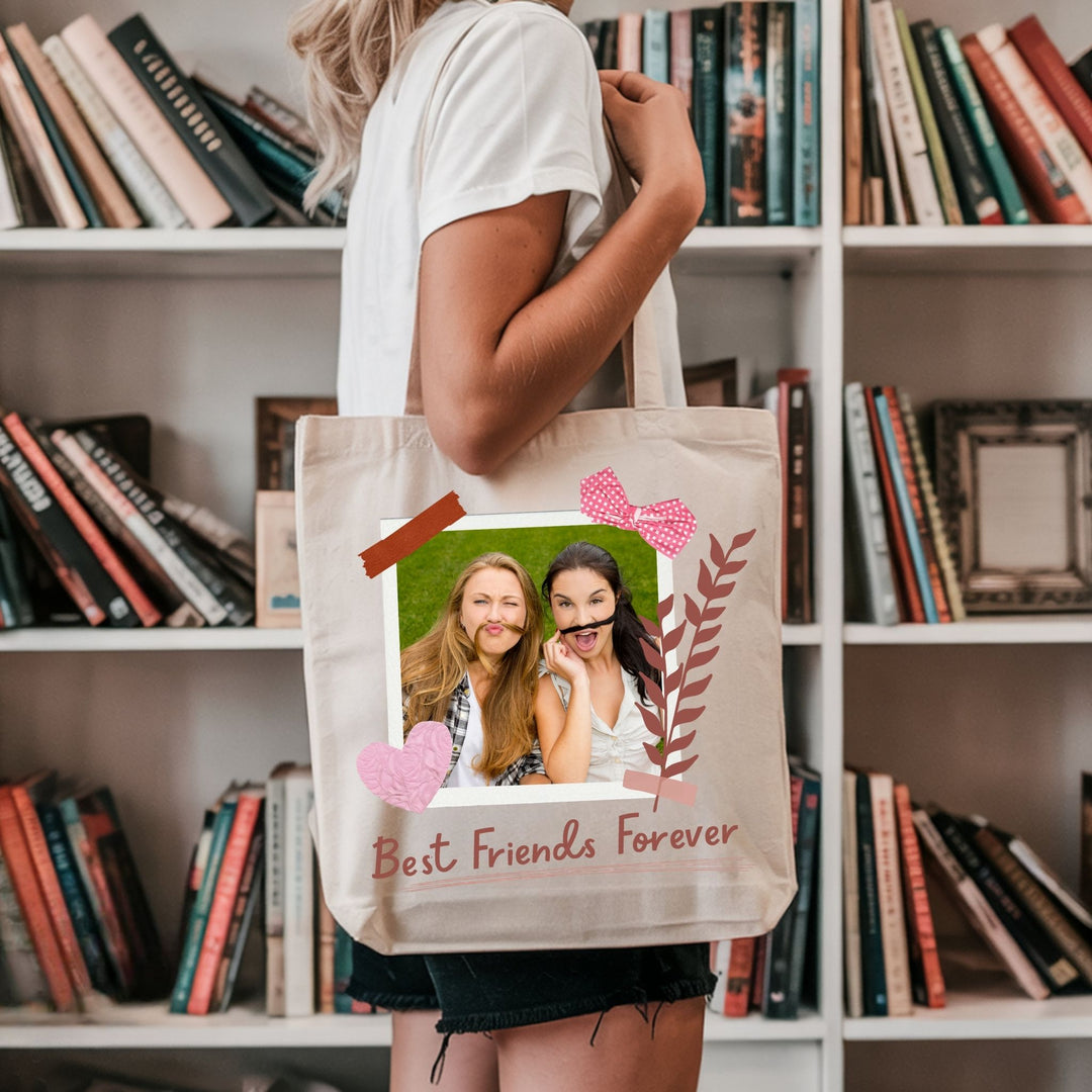 Personalised best friend photo tote bag held beside books in a lifestyle setting