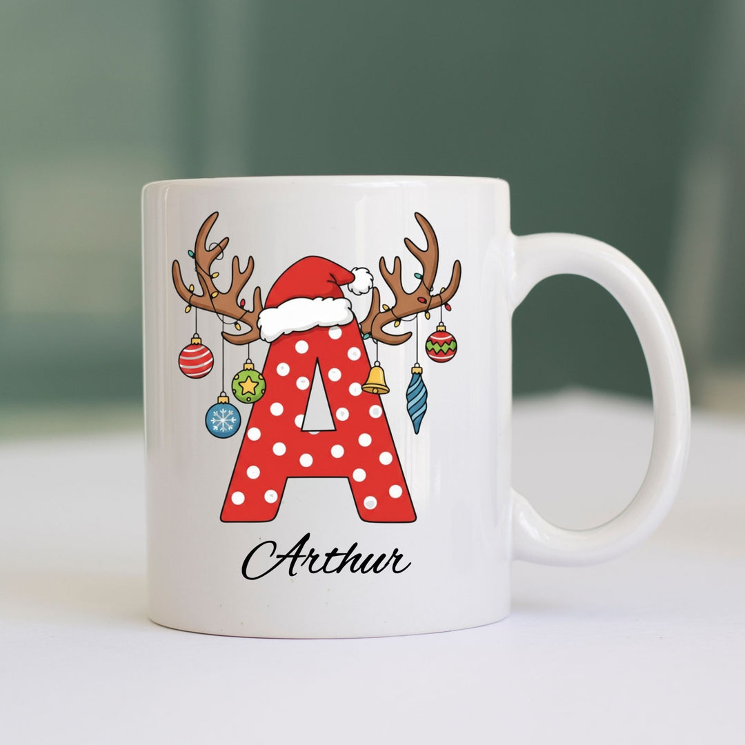 Personalised Christmas initial mug with red polka-dot letter, Santa hat, reindeer antlers and name