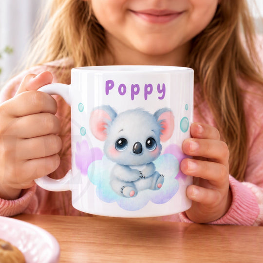 Close-up of personalised Koala Kids mug held in two hands, showing the name and koala print