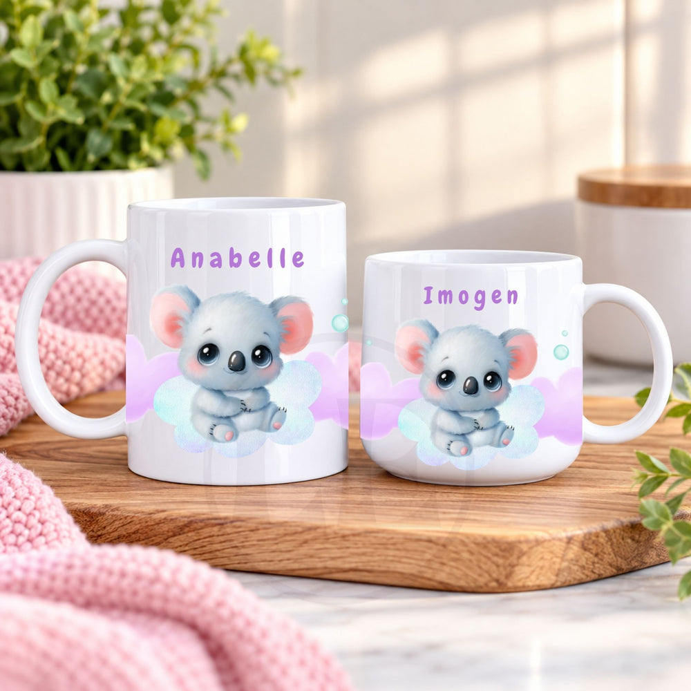 Two personalised Koala Kids mugs with names displayed together on a wooden surface